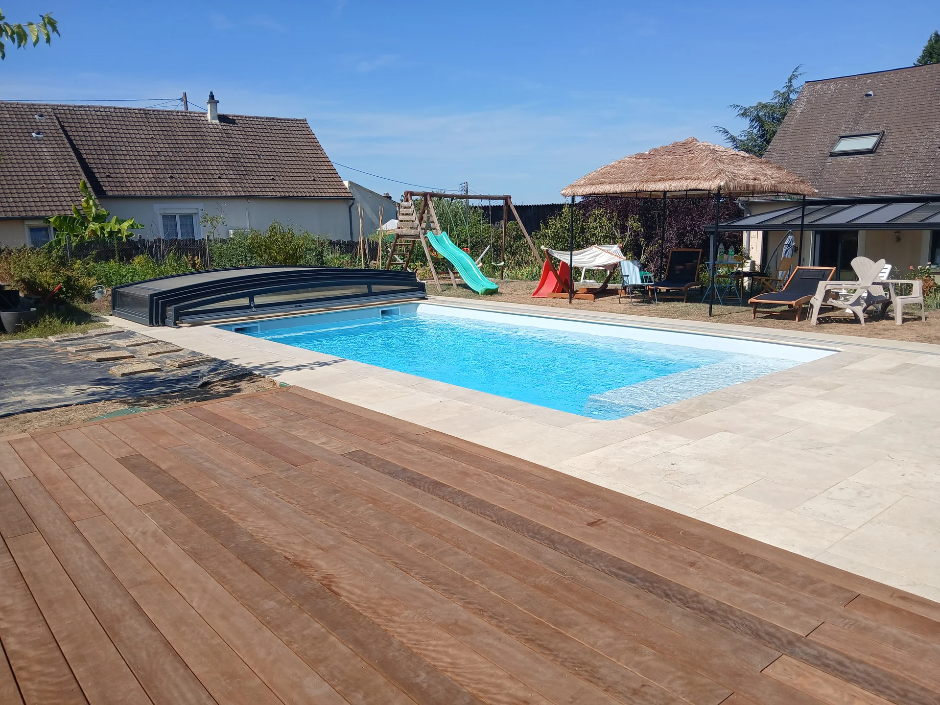 Vue d’ensemble d’une terrasse en bois et d’une piscine extérieure